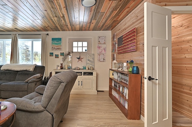 living room featuring wood ceiling, light hardwood / wood-style floors, and wood walls