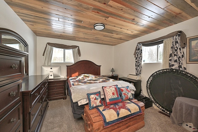 carpeted bedroom with multiple windows, vaulted ceiling, and wood ceiling