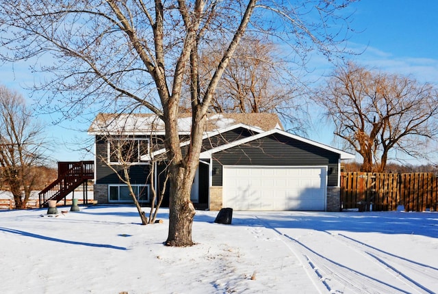 view of front facade with a garage and a wooden deck