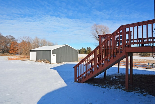 yard covered in snow with a garage and an outbuilding