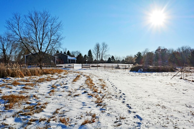 yard layered in snow featuring a rural view