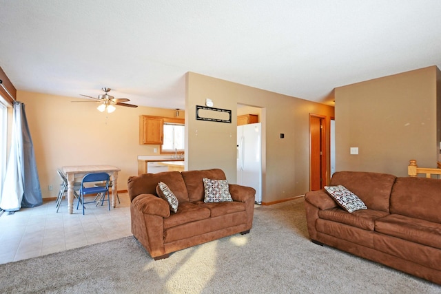 carpeted living room featuring ceiling fan