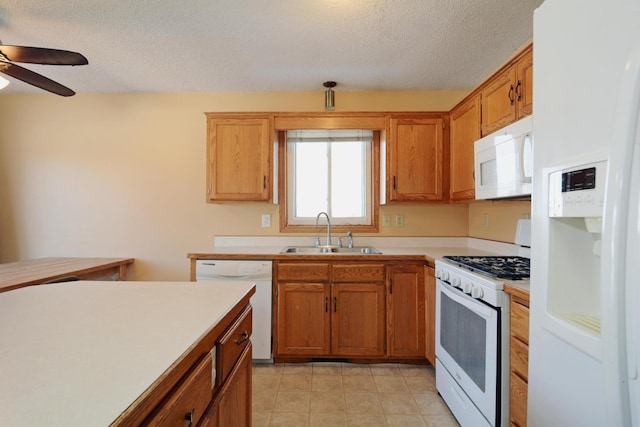 kitchen featuring ceiling fan, sink, a textured ceiling, and white appliances