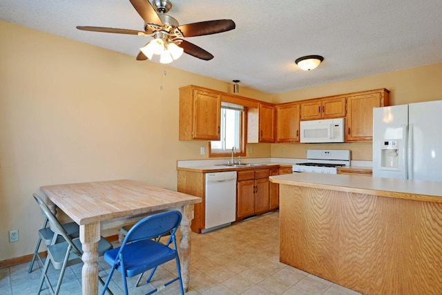 kitchen with sink, a textured ceiling, and white appliances