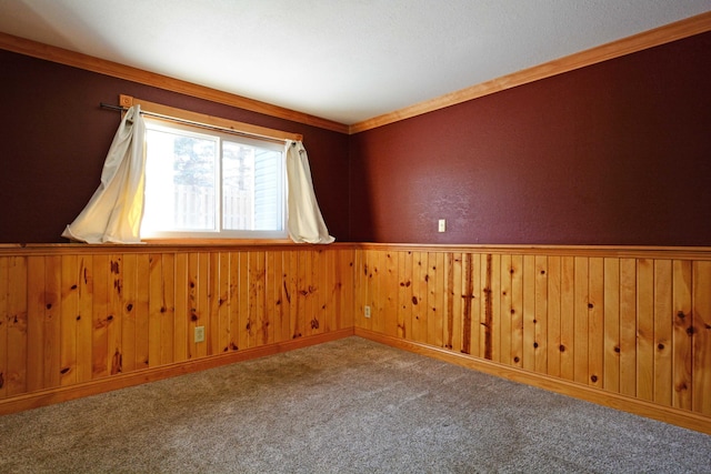 unfurnished room featuring ornamental molding and carpet floors