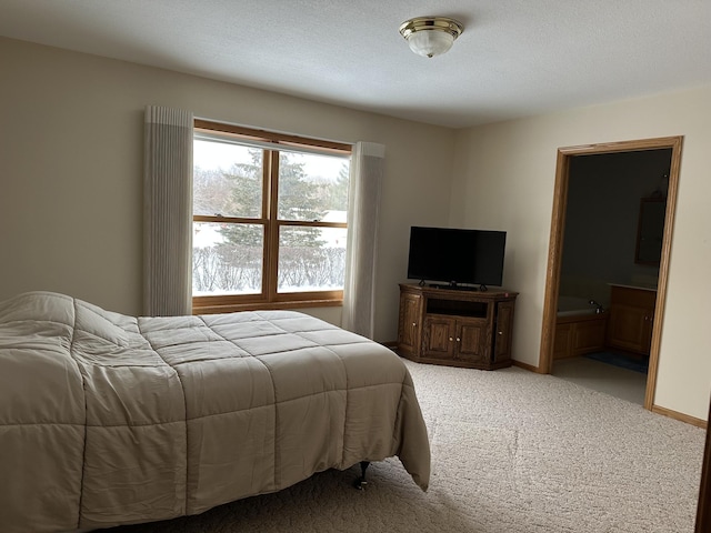 carpeted bedroom featuring ensuite bathroom