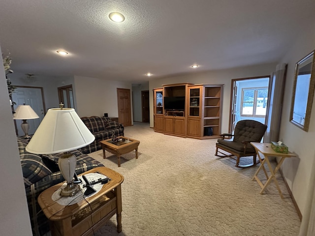 living room featuring carpet floors and a textured ceiling