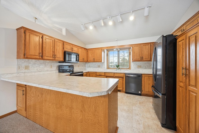 kitchen with a peninsula, vaulted ceiling, light countertops, black appliances, and a sink