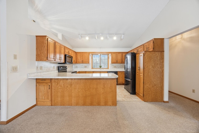 kitchen featuring lofted ceiling, brown cabinets, a peninsula, light countertops, and black appliances