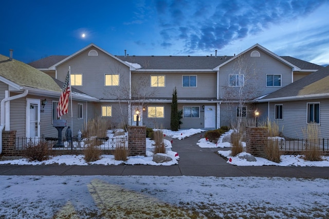 view of snow covered back of property