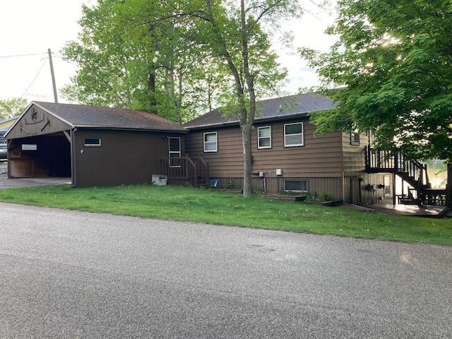 view of side of property with a garage and a yard