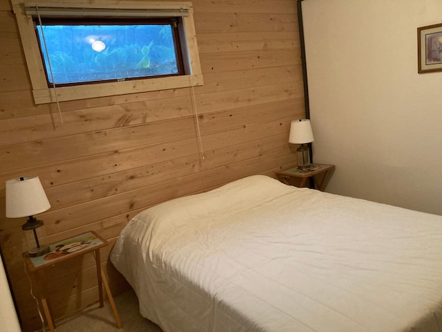 bedroom featuring wooden walls