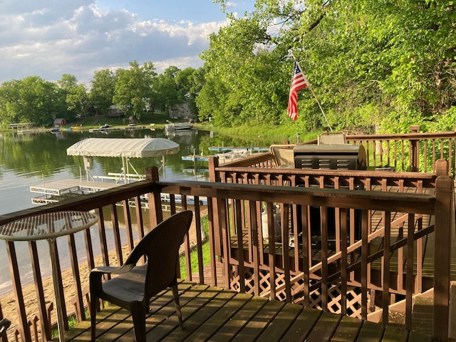 wooden deck featuring a water view and a boat dock