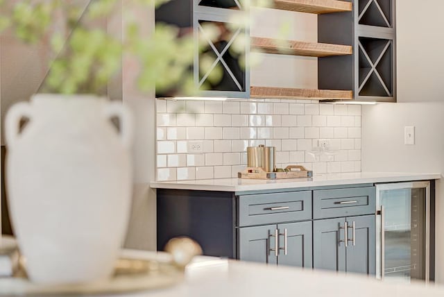 kitchen featuring gray cabinets, beverage cooler, and decorative backsplash