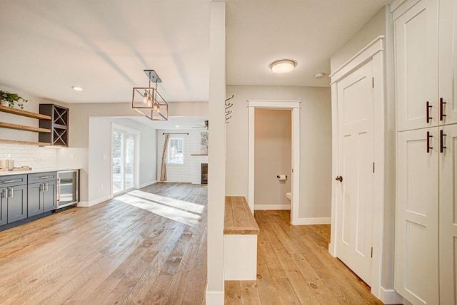 interior space featuring beverage cooler and light hardwood / wood-style floors