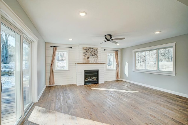 unfurnished living room featuring hardwood / wood-style floors and ceiling fan