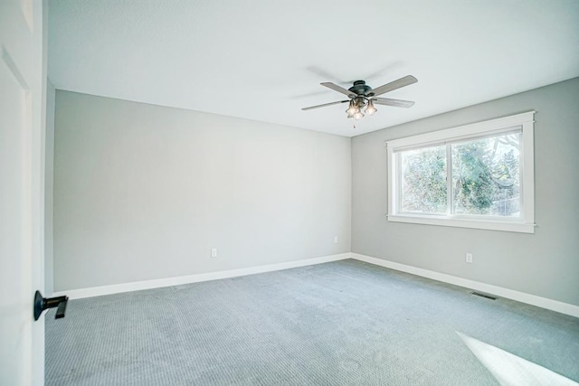 carpeted spare room with ceiling fan