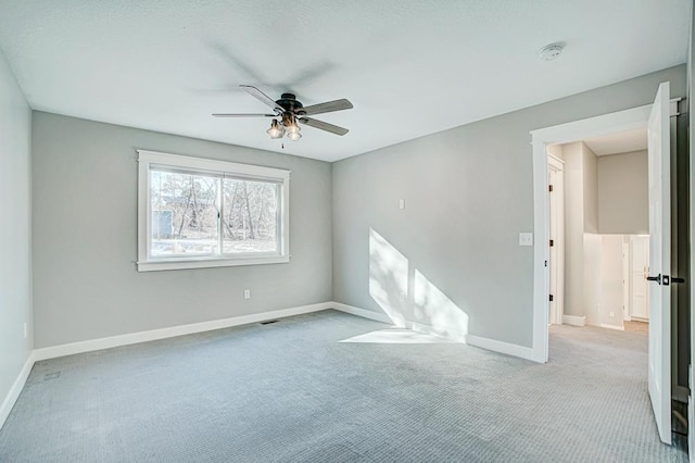 unfurnished room featuring light colored carpet and ceiling fan