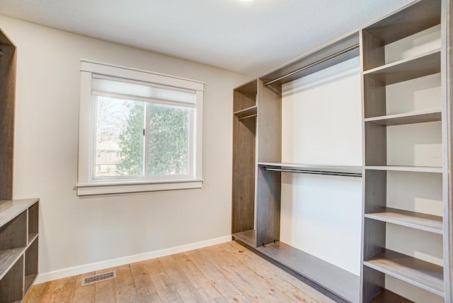 walk in closet featuring light hardwood / wood-style flooring