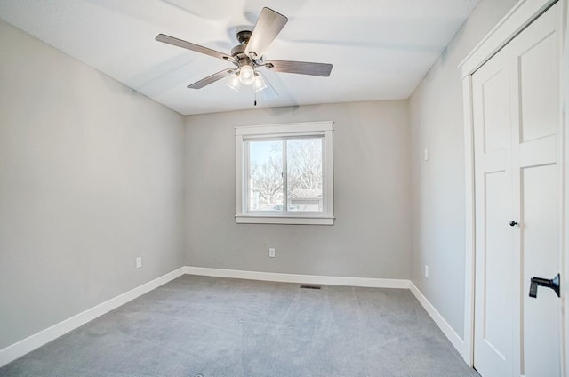 empty room with ceiling fan and carpet