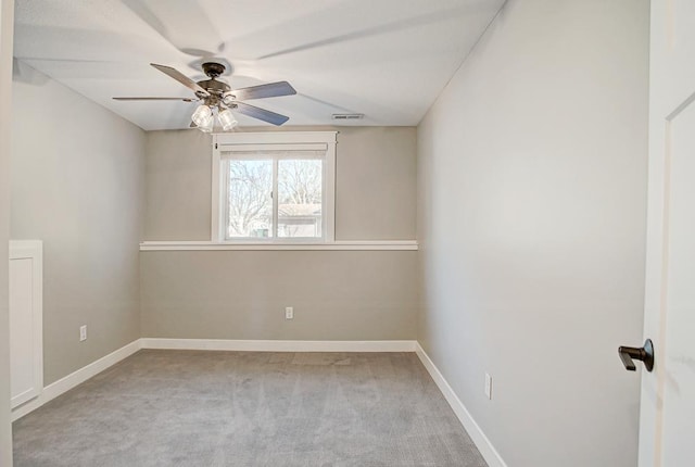 carpeted spare room with ceiling fan