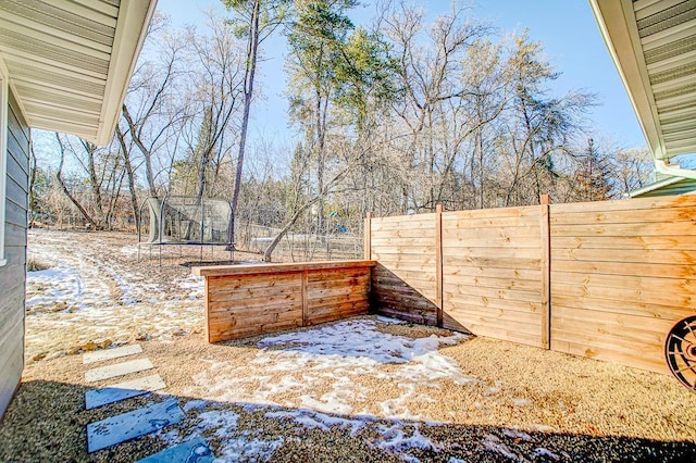 snow covered patio with a trampoline