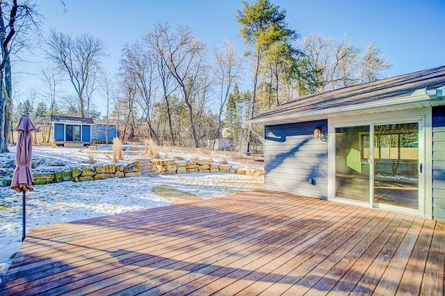 snow covered deck with an outdoor structure