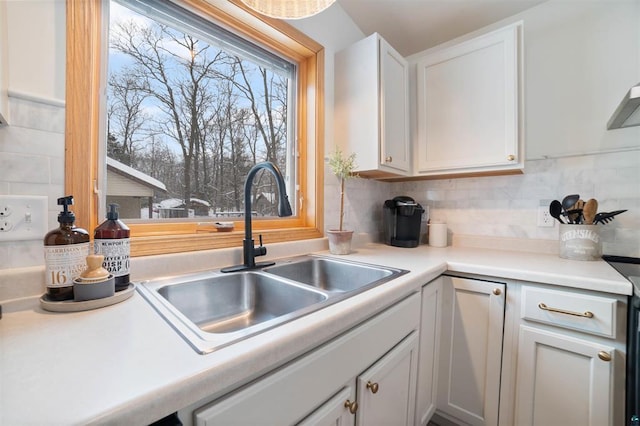 9505 Buskey Bay Dr, Iron River, WI 54847 - kitchen featuring a sink, decorative backsplash, and white cabinets