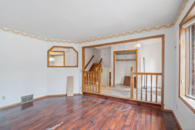 empty room with hardwood / wood-style floors