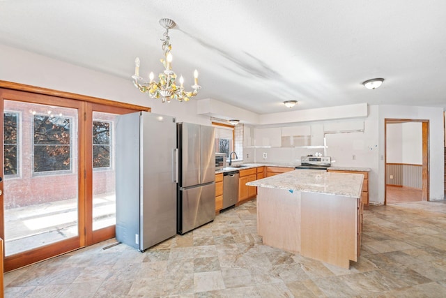 kitchen featuring sink, decorative light fixtures, plenty of natural light, and stainless steel appliances