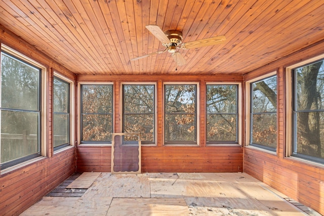 unfurnished sunroom with ceiling fan and wood ceiling