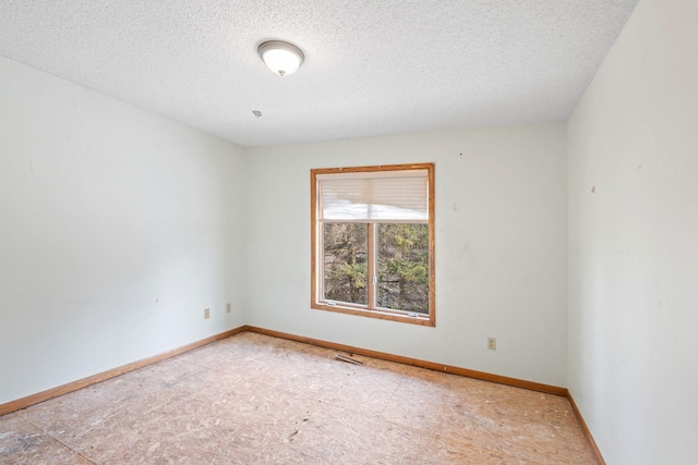 empty room featuring a textured ceiling