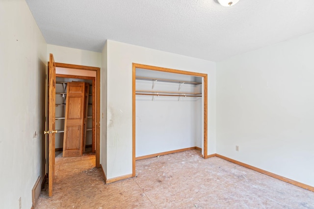 unfurnished bedroom featuring a closet and a textured ceiling