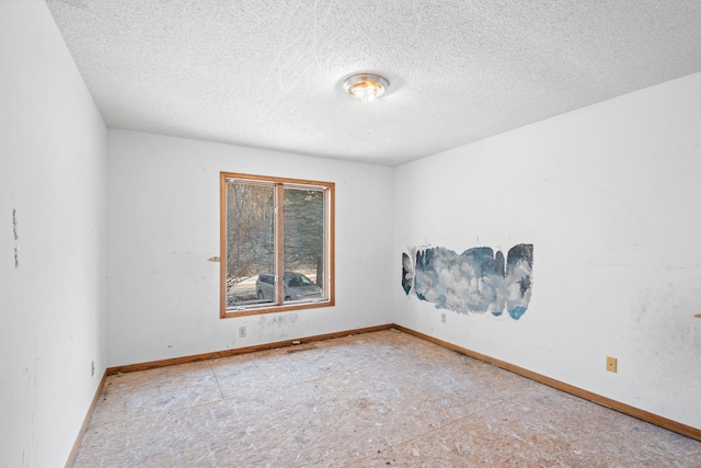 unfurnished room featuring a textured ceiling