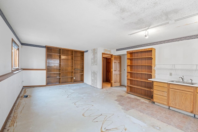 interior space with sink and a textured ceiling