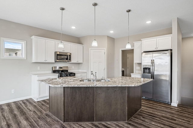 kitchen with a sink, dark wood-type flooring, appliances with stainless steel finishes, and white cabinetry