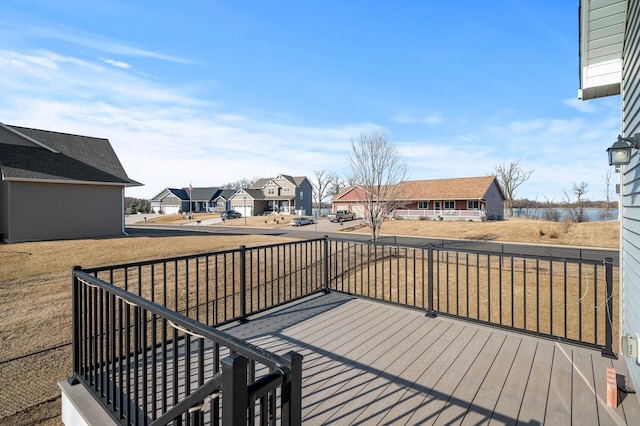 wooden deck featuring a residential view and a water view