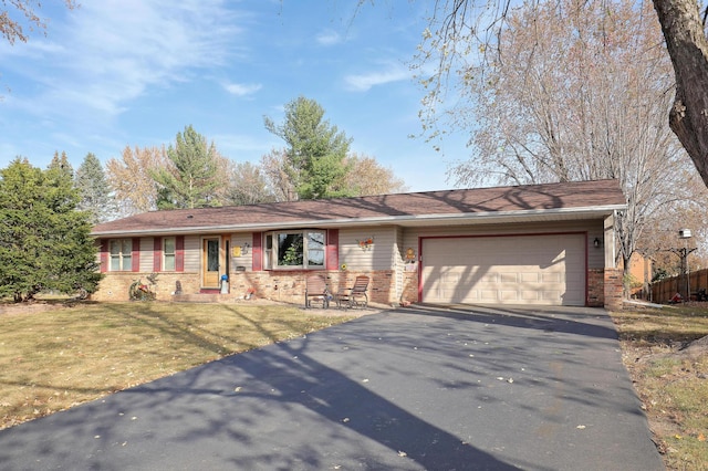 ranch-style home with a garage and a front lawn