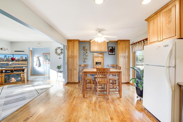 kitchen with ceiling fan, light hardwood / wood-style floors, and white fridge