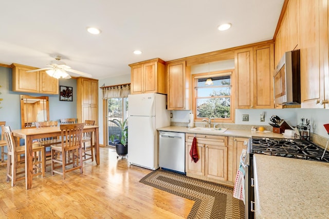 kitchen with sink, ceiling fan, stainless steel appliances, light hardwood / wood-style floors, and light brown cabinetry