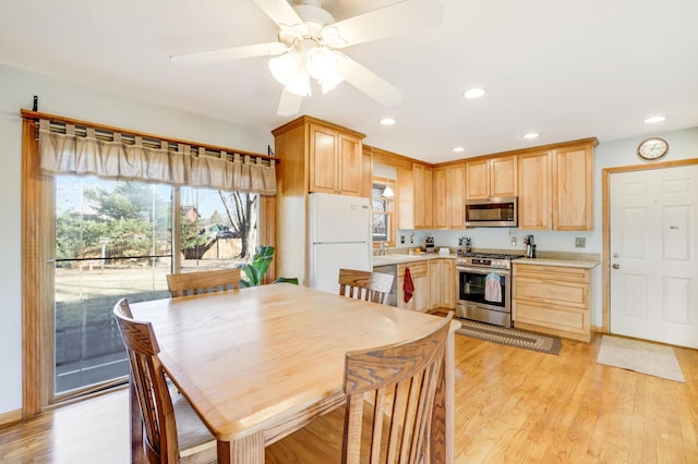 kitchen featuring sink, ceiling fan, stainless steel appliances, light brown cabinetry, and light wood-type flooring