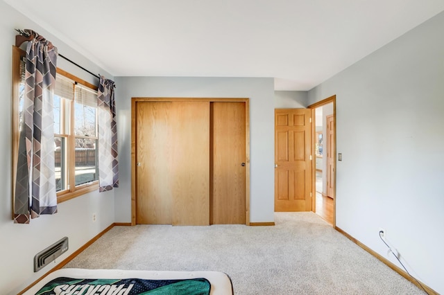 carpeted bedroom featuring a closet