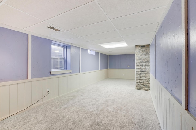 basement with carpet floors and a drop ceiling