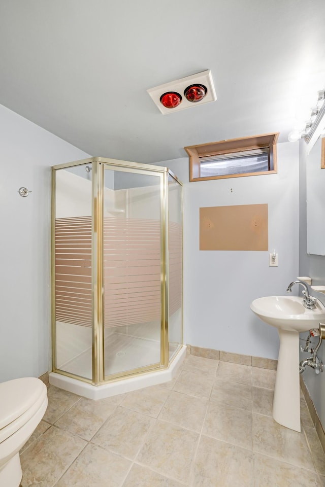 bathroom with toilet, sink, tile patterned floors, and walk in shower