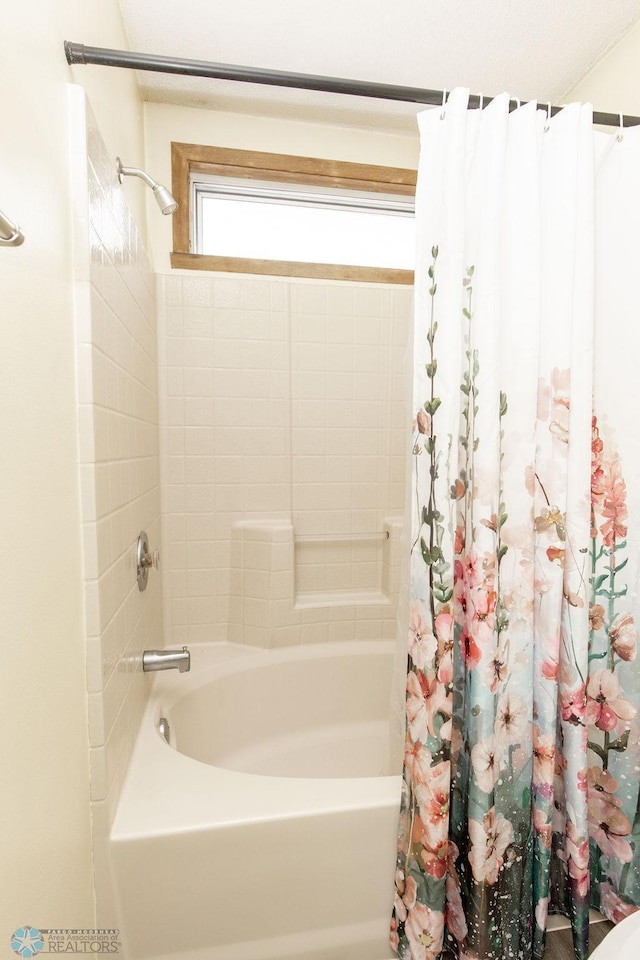 bathroom featuring shower / bath combo with shower curtain