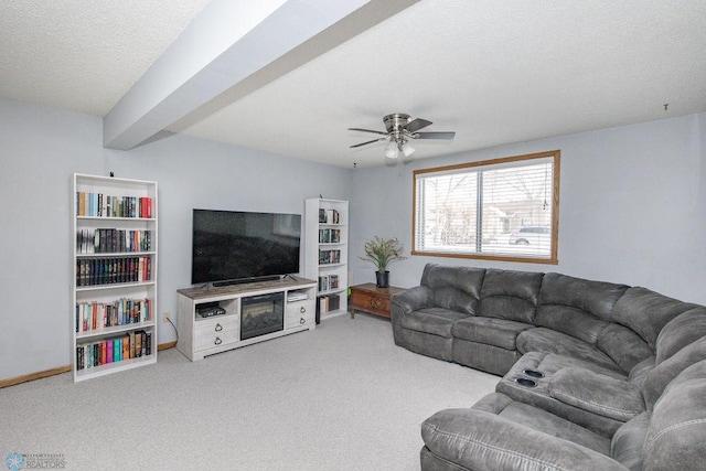 carpeted living room with ceiling fan and a textured ceiling