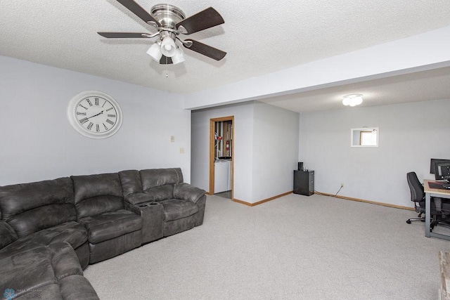 living room featuring ceiling fan, light colored carpet, and a textured ceiling