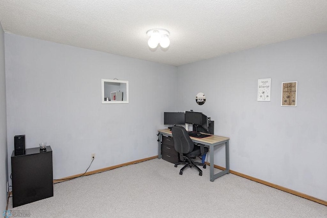 carpeted office space featuring a textured ceiling