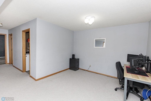 home office with light colored carpet and a textured ceiling