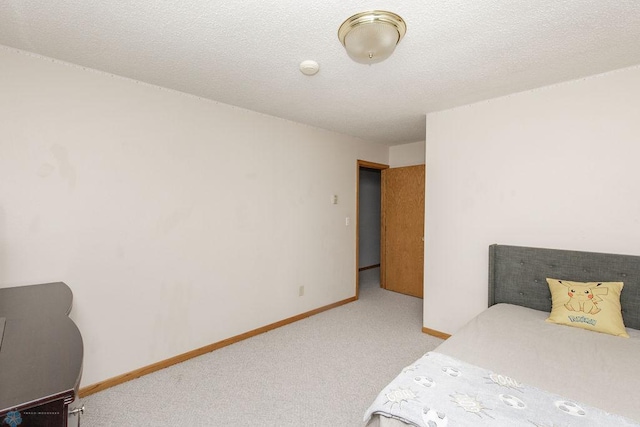 carpeted bedroom with a textured ceiling